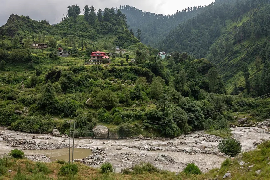 Thannamandi hillside village and stream