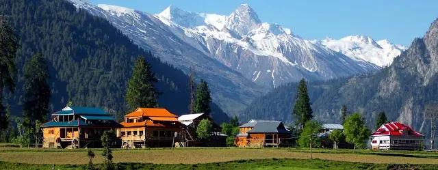 Alpine cottages under snow peaks